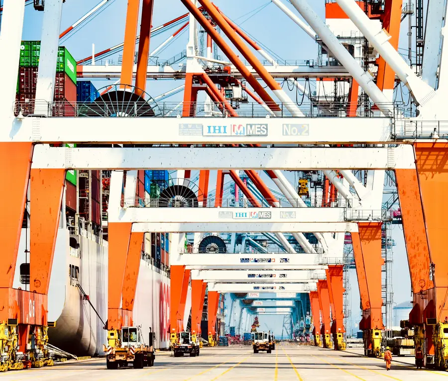 Grúas pórtico de color naranja alineadas en un terminal de contenedores